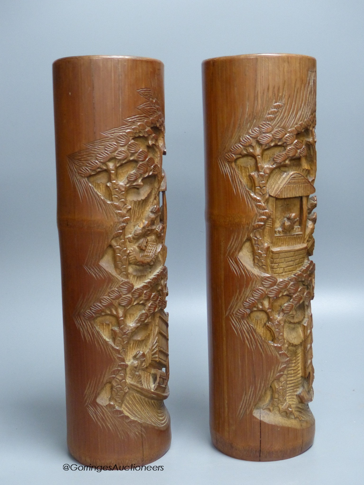 A pair of Chinese bamboo brush pots, carved with scholars in gardens, height 36cm